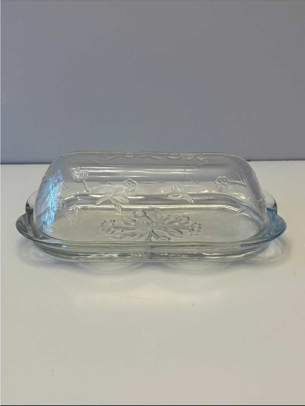 Anchor Hocking Savannah butter dish features a pressed clear glass design flower
